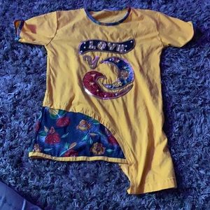 Yellow shirt with beads and a flower slight
